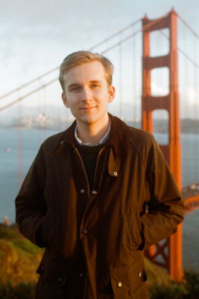 Portrait of Jerome Paulos standing in front of the Golden Gate Bridge